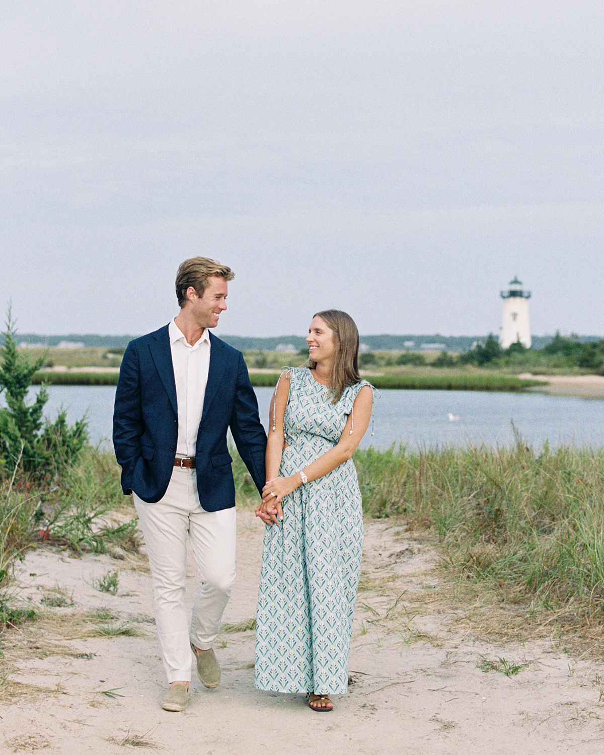 couple walking at lighthouse beach in edgartown, martha's vineyard